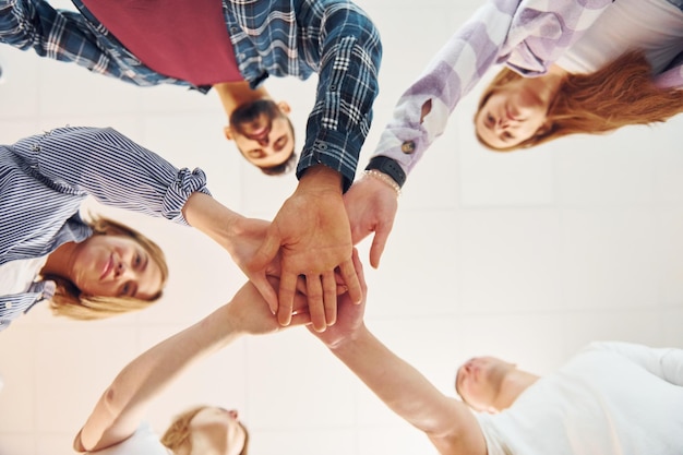 Holding each other's hands Group of friends standing together