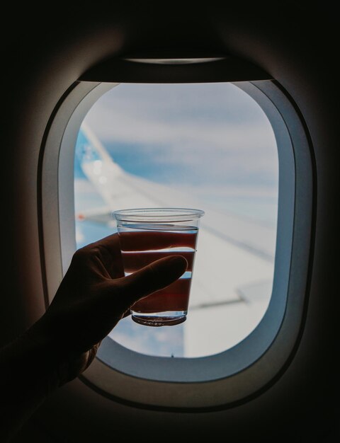 Holding glass of water in the airplane