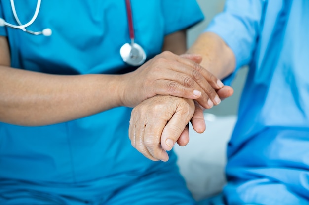 Holding hand senior lady patient with love