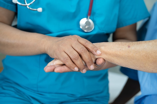 Holding hands Asian senior woman patient with love