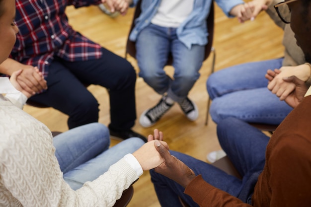 Photo holding hands in support group closeup