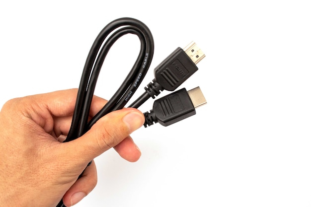 holding HDMI cable connector on white background