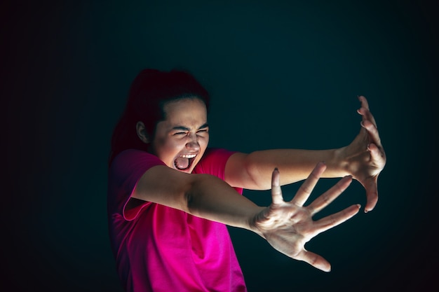 Photo holding head portrait of young crazy scared and shocked caucasian woman isolated