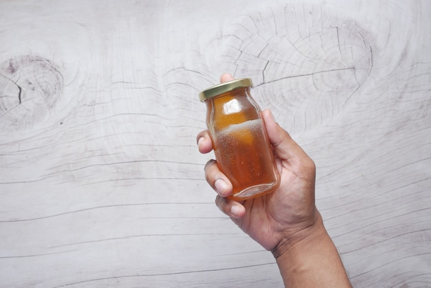 Holding a jar of fresh honey top view