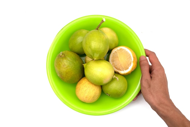 holding a lemon on a plate on a white background