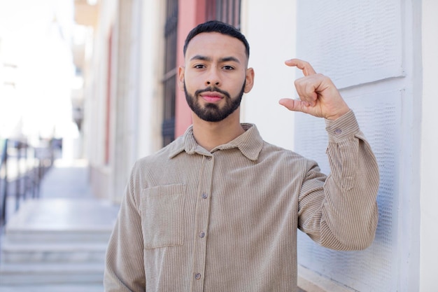 Holding an object showing offering or advertising something small