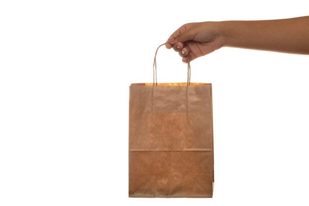 Holding paper shopping bag on white background