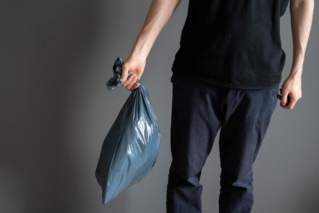 Holding plastic garbage bag take out the trash