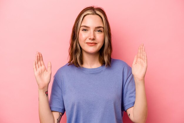 Holding something little with forefingers smiling and confident