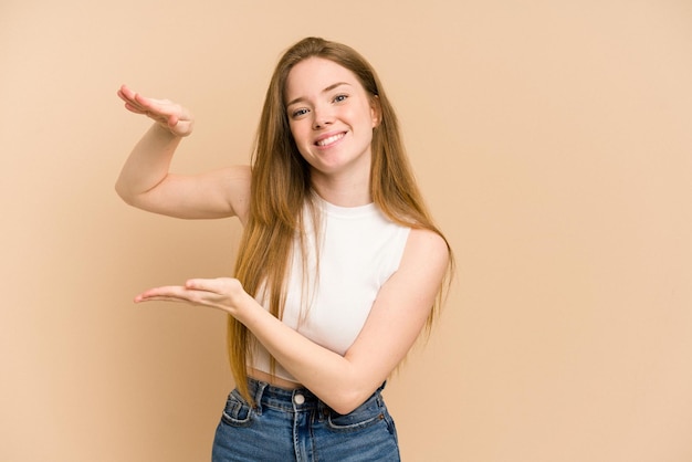 Photo holding something little with forefingers smiling and confident