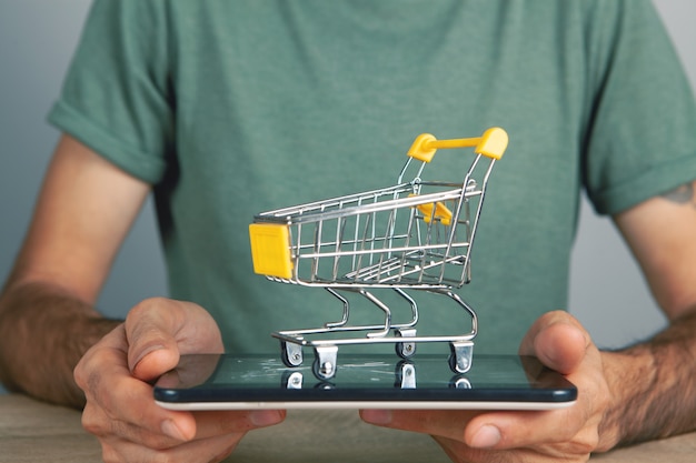 Holding a tablet with a shopping basket