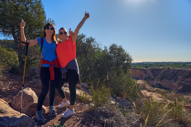 Photo holding together hiking in the mountain