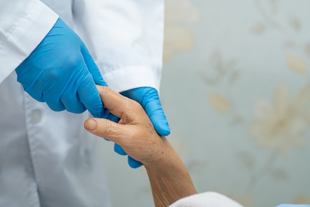 Holding Touching hands Asian senior or elderly old lady woman patient with love, care, helping, encourage and empathy at nursing hospital ward : healthy strong medical concept