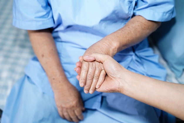 Holding Touching hands Asian senior or elderly old lady woman patient 