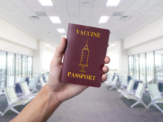 Holding a vacine passport at the airport terminal