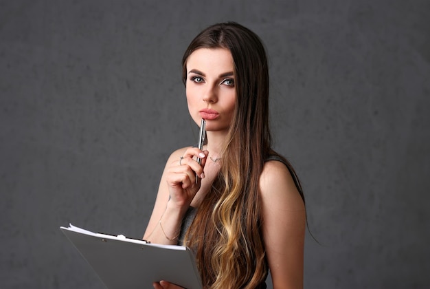 Holds a clipboard with financial statistics fashion style curly