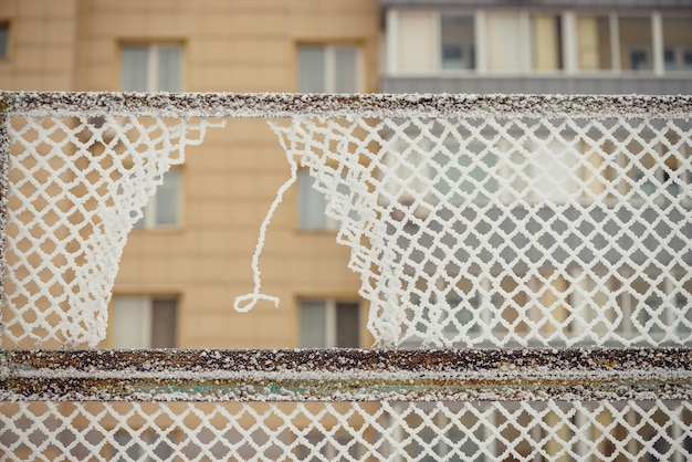 Photo hole in chainlink fence close up