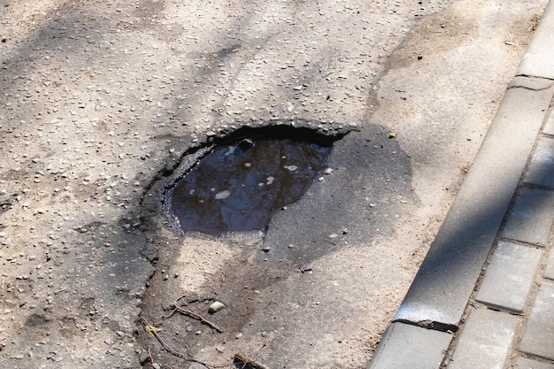 Hole in the pavement on the road