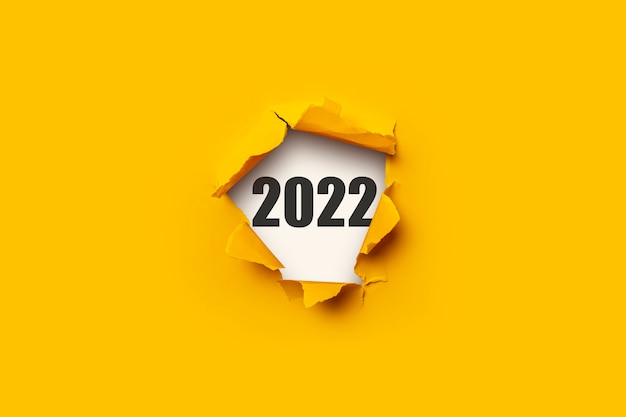 Hole in the wall and the text 2022. Concept New Year.