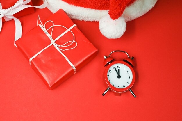 Holiday background with a christmas presents and red alarm clock. Time to shopping concept. High quality photo