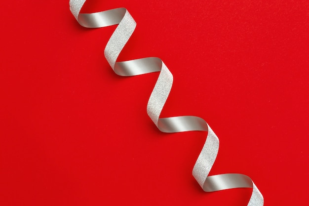 Holiday background with copy space. Silver spiral ribbon 