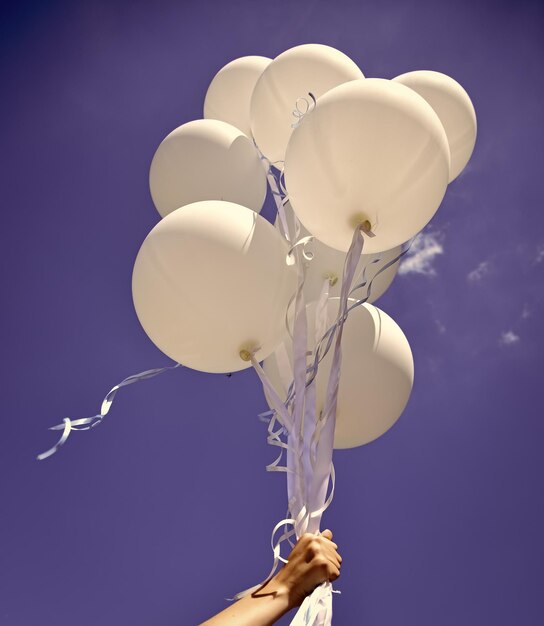 Holiday balloons fly on in blue sky