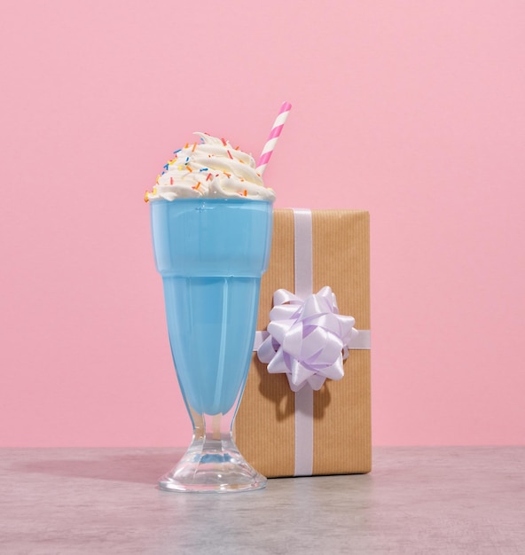 Holiday and birthday party idea Blue milkshake with straw and nice gift