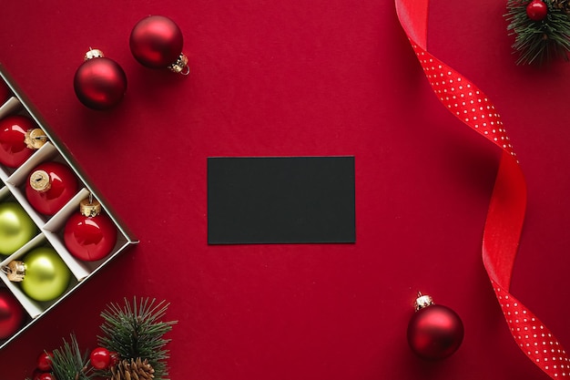 Holiday brand identity design and christmas flatlay concept black blank business card and xmas ornam...