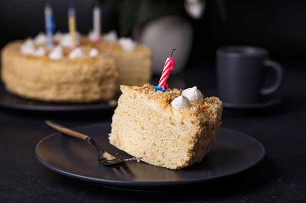 Holiday cake with crumbly shortcrust pastry and mini meringue Birthday cake with extinguished candles Homemade baking Black background selective focus closeup