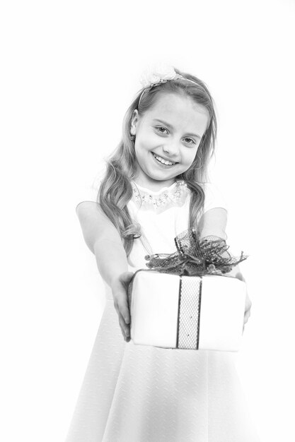 Holiday celebration and mothers day Small girl with gift box with red bow in dress Child or happy kid with present pack isolated on white background Christmas and birthday Childhood and happiness