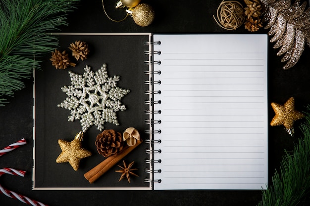 Holiday Christmas frame card and vintage blank open book notes on the dark table