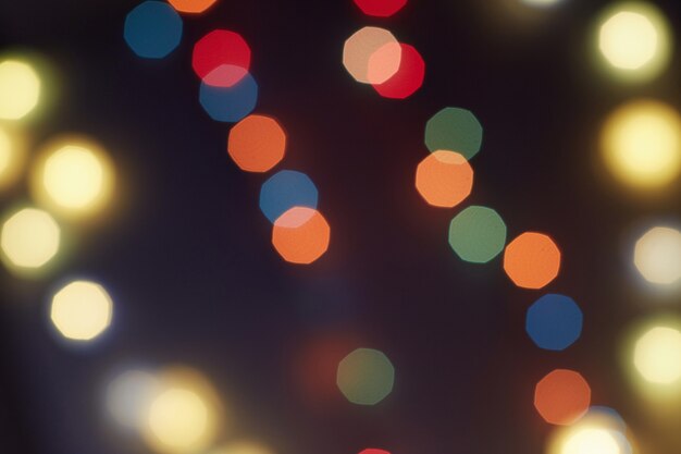 Holiday Christmas glowing color lights with sparkles, blurred bright Christmas abstract bokeh