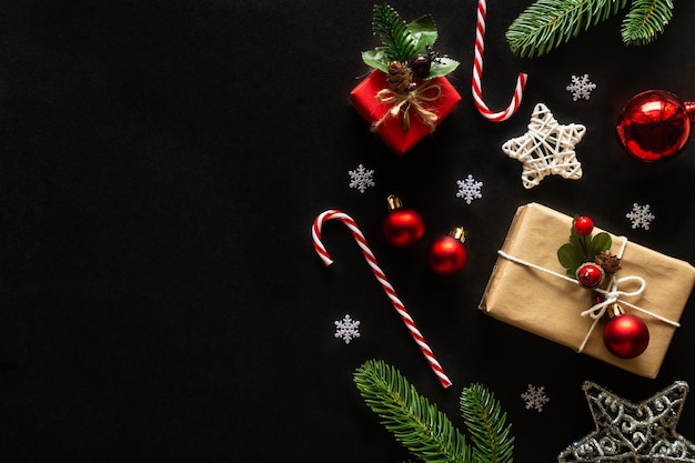 holiday christmas with decoration ball starssnowflakes gift box pine cones on a black background