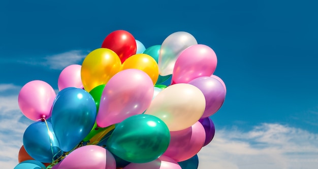 Holiday concept. Bunch of colorful balloons on a  sky background