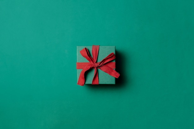 Holiday gift box on Paolo Veronese Green color background. Above view