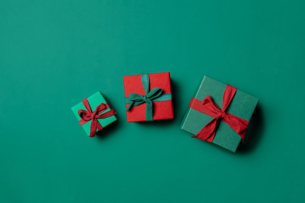 Holiday gift boxes on Paolo Veronese Green color background. Above view