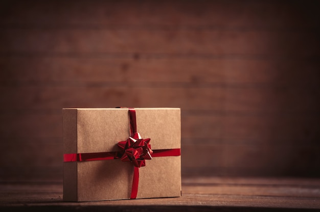 Holiday gift on wooden table and background