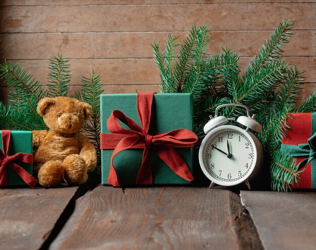 Holiday gifts and boxes on wooden table.