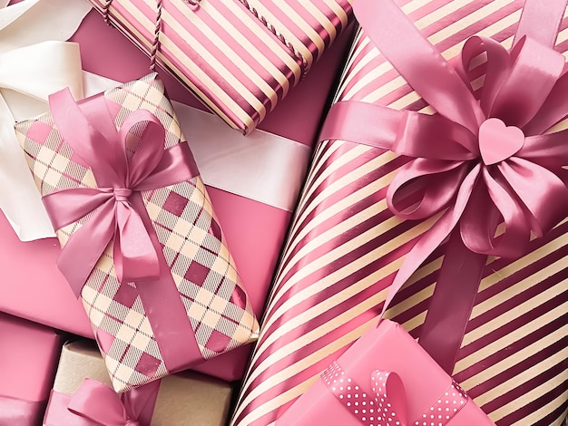 Holiday gifts and wrapped luxury presents pink gift boxes as surprise present for birthday Christmas New Year Valentines Day boxing day wedding and holidays shopping or beauty box delivery