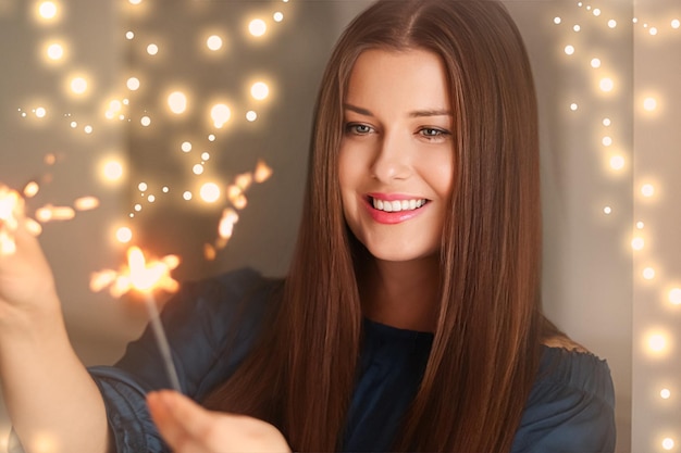 Holiday magic Christmas and New Year celebration happy woman with sparklers