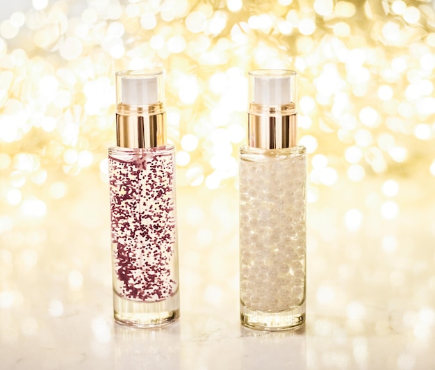 Holiday makeup base gel serum emulsion lotion bottle and golden glitter luxury skin and body care cosmetics for beauty brand ads