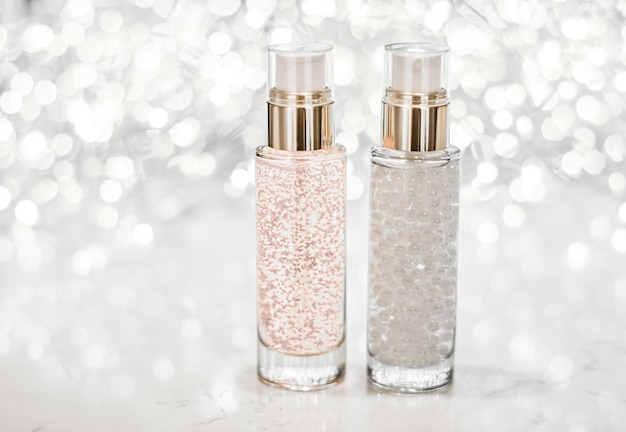 Holiday makeup base gel serum emulsion lotion bottle and silver glitter luxury skin and body care cosmetics for beauty brand ads