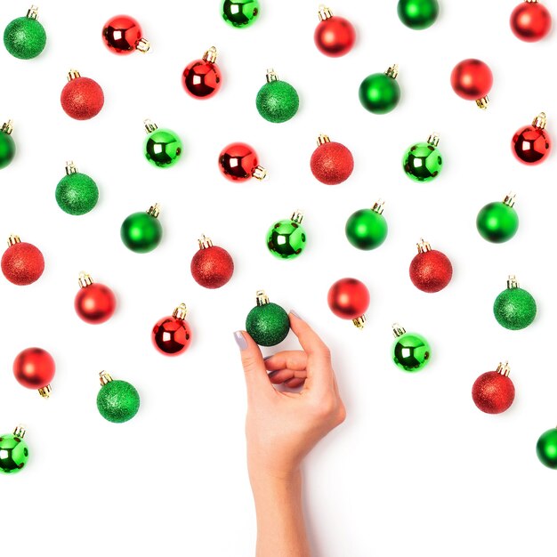 Holiday pattern  made of red and green Christmas balls on white background. Flat lay, top view