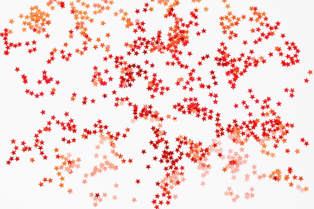 Holiday   red and orange star confetti. 