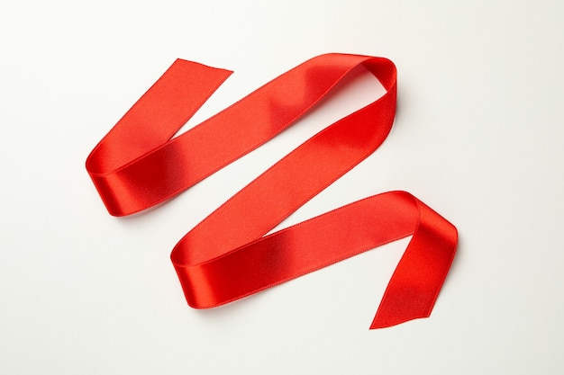 Photo holiday red ribbon on white background, close up