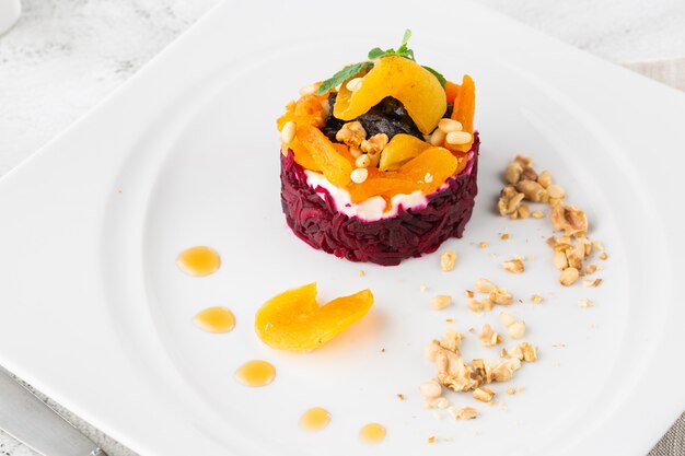 Holiday salad of beets and soft cheese in glasses. Portion salad dressing herring under a fur coat. The classic salad of Russian cuisine. Layer of herring, potatoes, carrots, beets and mayonnaise.