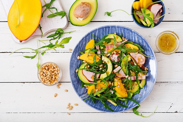 Holiday salad with smoked chicken, mango, avocado and arugula.