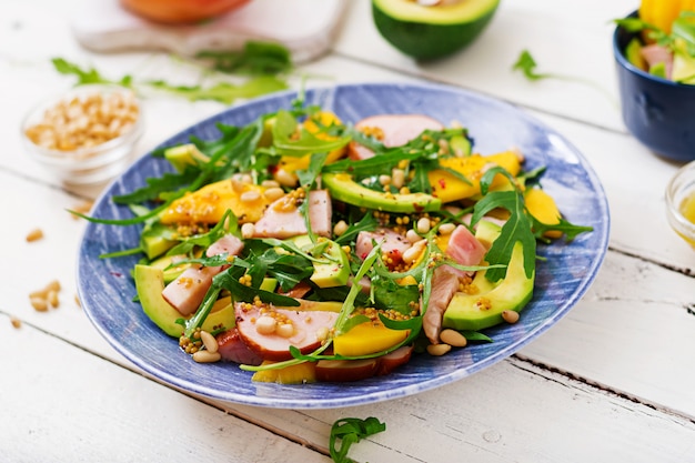 Holiday salad with smoked chicken, mango, avocado and arugula