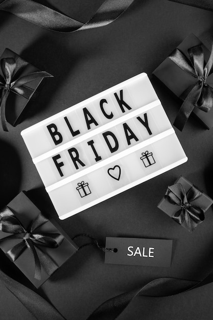 Holiday sales concept with black boxes sale tag light box with letters Black Friday on black