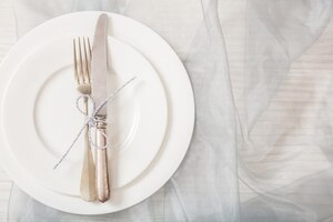 Photo holiday table place setting with plates fork and knife copy space